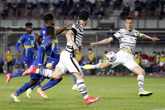 Korea's Kim Shin-wook, right, scores the opening goal after receiving a header from Nam Tae-hee, center, in a World Cup qualifying match between Korea and Sri Lanka at Goyang Stadium in Goyang, Gyeonggi, on Wednesday. [NEWS1]