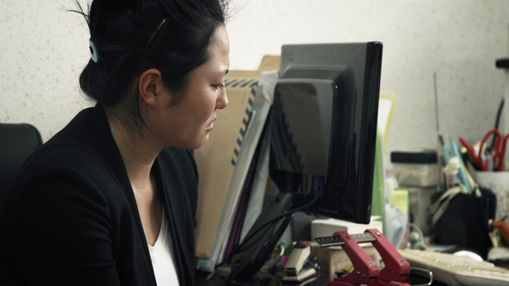 A shot of Engelstoft from the film asking the director of the Aesuhwon shelter for single mothers, to look into her files for her. [CONNECT PICTURES]       
