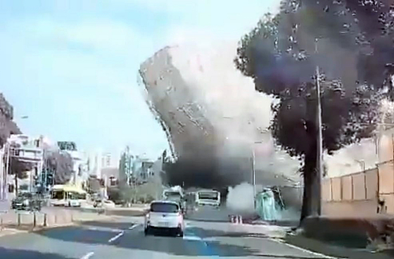 In this image from a car's black box, a five-story building collapses during demolition and falls on a bus in Gwangju on Wednesday.  [NEWS1] 