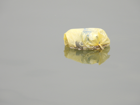 A trash bag floating on Gulpo Stream in Incheon. [KANG CHAN-SU]