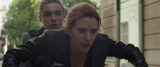 Natasha comes in contact with long-lost family members in "Black Widow." Behind Natasha is Yelena Belova, a sister-figure to Natasha played by Florence Pugh. [WALT DISNEY COMPANY KOREA]