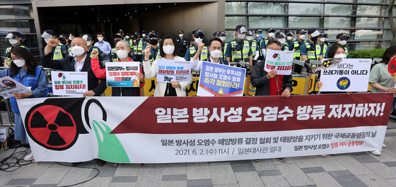 Civic groups hold a press conference to condemn the Japanese government’s plan to release contaminated water from its Fukushima nuclear power plant near the Japanese Embassy in central Seoul on June 2. [NEWS1]