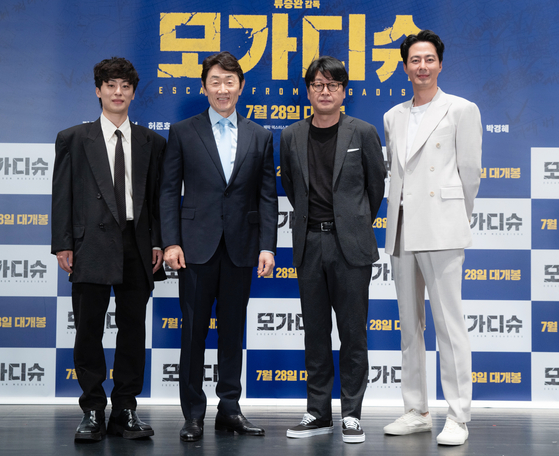  Leads in the highly anticipated “Escape from Mogadishu” — from left, actors Koo Kyo-hwan, Huh Joon-ho, Kim Yoon-seok and Zo In-sung — pose at an online press event Thursday. [LOTTE ENTERTAINMENT]