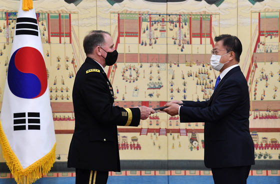 Korean President Moon Jae-in, right, awards the Tongil Medal, Korea's highest national security merit, to Gen. Robert Abrams, outgoing commander of the U.S. Forces Korea, at the Blue House in Seoul on Thursday. [JOINT PRESS CORPS] 