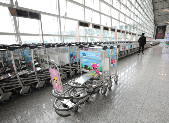Baggage carts stand empty at a passenger terminal in Incheon International Airport on Wednesday. Despite expectations that the travel industry would begin to recover as inoculations increase, the increasing number of Covid-19 cases is expected to again stall overseas travel. [NEWS1] 