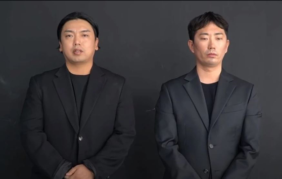 Comedian Kwak Beom, left, and comedian Lee Chang-ho are the real men behind Mad Monster members Tan and J.Ho. [SCREEN CAPTURE]