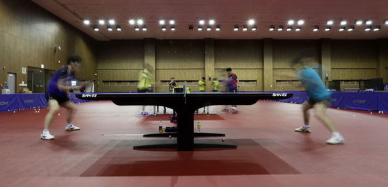 Table tennis players practice at the Jincheon National Training Center in Jincheon, North Chungcheong on April 14, a hundred days ahead of the Tokyo Olympics. [JOINT PRESS CORPS]