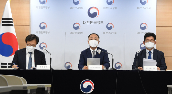Finance Minister Hong Nam-ki attends a press briefing on tax reforms at the government complex in Sejong on Friday. [MINISTRY OF ECONOMY AND FINANCE]