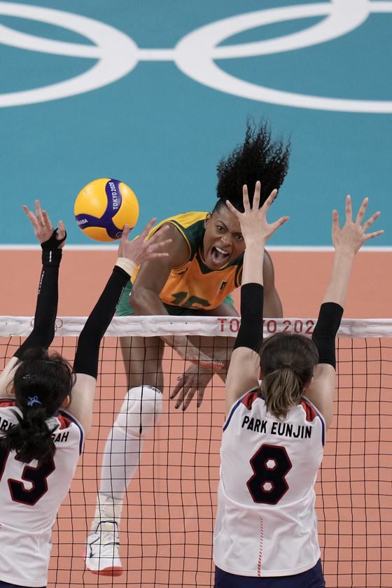Brazil's Fernanda Garay Rodrigues, center, spikes a ball during a women's volleyball semifinal match against Korea, at the 2020 Summer Olympics on Friday in Tokyo. [AP/YONHAP]
