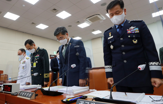 In this file photo at a National Assembly hearing on June 9, 2021, military leaders pray a silent prayer for an Air Force officer who committed suicide after reporting sexual harassment by her colleague. Defense Minister Suh Wook is second from right. [YONHAP]