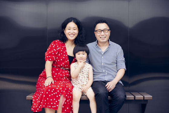 Director ParkKang A-reum, left, and her family pose for photos after the press screening of her documentary "Areum Married," at CGV Yongsan branch in central Seoul last week. The film is set for release at local theaters on Thursday. [JINJIN PICTURES]
