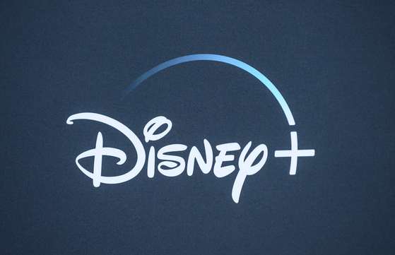 In this file photo, the Disney logo is seen on the backdrop for the World Premiere of ″The Mandalorian″ at El Capitan theatre in Hollywood on November 13, 2019. [AFP/YONHAP]