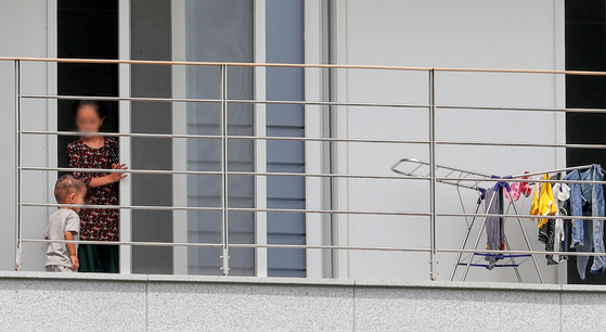 Two Afghans are pictured Sunday on a balcony of a facility in Jincheon County, North Chungcheong, where the evacuated Afghans are staying quarantined for two weeks, after which they will start a procedure to settle in Korea. The Korean government evacuated 390 Afghans out of Kabul last week. They are people who have worked with the Korean government and their families. [NEWS1]