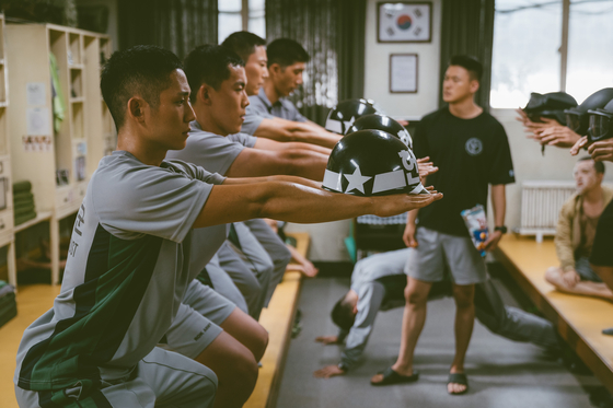 A scene from the Netflix series "D.P." where lower ranking soldiers are punished as a group. [NETFLIX]