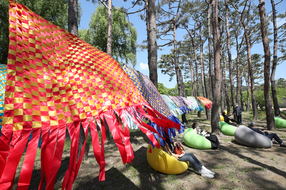 Sound bath instructor Choi Seo-hong holds a sound bath session during this year's "Royal Culture Festival" held in May at Changdeok Palace in central Seoul. [NEWS1] 