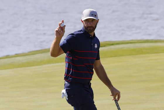 Dustin Johnson reacts after holing his birdie putt on the 5th green to win the hole during the Four-balls at the 2020 Ryder Cup held at Whistling Straits, Sheboygan, Wisconsin on Sept. 24. [REUTERS/YONHAP]