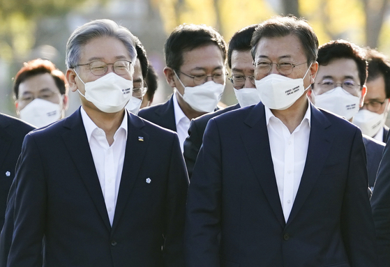 President Moon Jae-in, right, and Gyeonggi, Gov. Lee Jae-myung, the ruling Democratic Party’s presidential candidate, briefly chat at an event announcing a new national strategy for balanced regional development Thursday at Sejong City, attended by leaders of all 17 municipal and provincial governments. [NEWS1]