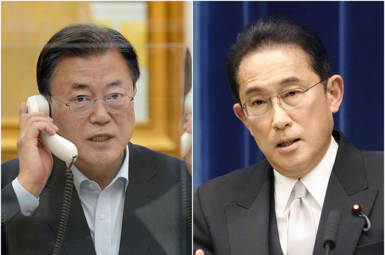 President Moon Jae-in, left, speaks over the phone with Japanese Prime Minister Fumio Kishida on Friday. [YONHAP]