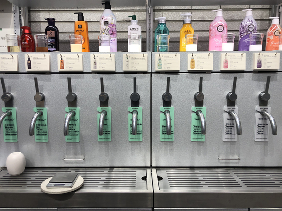 At refill stores, customers can bring in plastic containers they already own and fill them back up with products, paying per liter. [YOO JI-YOEN]
