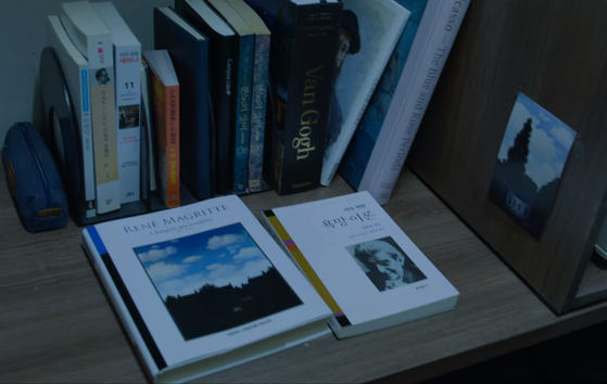The images seen from the desk of a policeman’s missing brother show “The Empire of Light” by Rene Magritte. [NETFLIX]