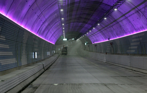 A car drives through the Boryeong Undersea Tunnel in South Chungcheong, before its opening. The tunnel will be Korea's longest underwater tunnel, running 6.927 kilometers (4.3 miles) between Sinheuk-dong and Wonsando, both in South Chungcheong. The tunnel will open on Dec. 1. [YONHAP] 