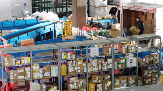 Employees of the Incheon Regional Customs office separate packages at a logistics center after a surge in orders from China’s Singles Day and Black Friday, according to the Korea Customs Service. [NEWS1]
