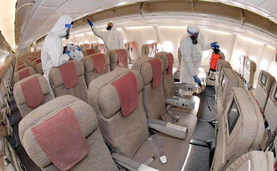 An Airbus A330 is disinfected at the Asiana Airlines' hangar at Incheon International Airport in Incheon on Thursday. Airlines have been regularly disinfecting aircrafts as a precautionary measure during the Covid-19 pandemic. [JOINT PRESS CORPS] 