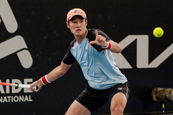 Kwon Soon-woo hits a return against Sweden's Michael Ymer during their men's singles match at the Adelaide International tennis tournament in Adelaide on Wednesday. [AFP/YONHAP]