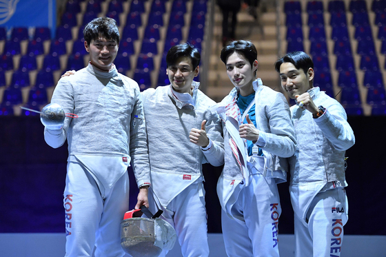 From left to right, Oh Sang-uk, Gu Bon-gil, Kim Jun-ho and Kim Jung-hwan pose after winning the men's team sabre final match between Korea and Germany at the Fencing World Cup 2022 in Tbilisi, Georgia on Monday. [XINHUA/YONHAP]