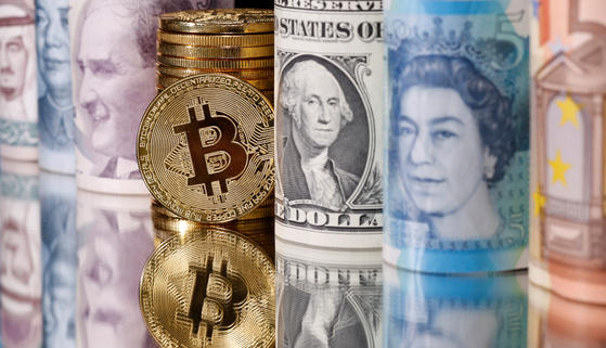 Representations of Bitcoin and fiat currencies, including the dollar and Turkish lira. [REUTERS/YONHAP]