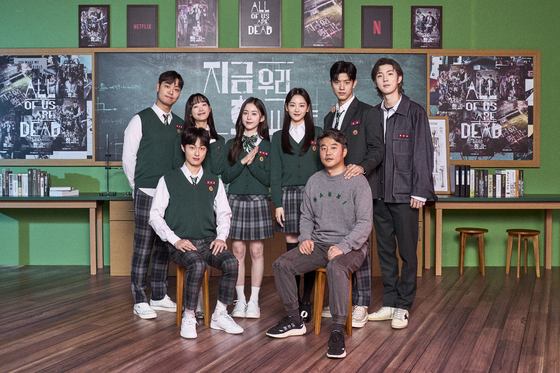 The cast of "All of Us Are Dead" and director Lee JQ, far right in front, pose for a photo at an online press event to promote their series on Wednesday. [NETFLIX]              