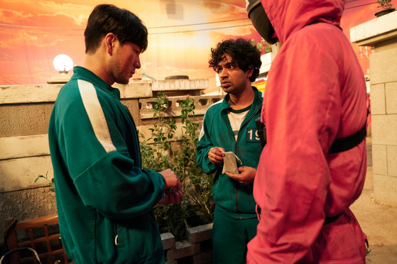 Anupam Tripathi,right, playing Abdul Ali on “Squid Game.” [NETFLIX] 