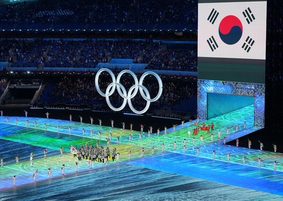 The Olympic delegation of the Republic of Korea, left, parade into the National Stadium in Beijing during the opening ceremony of the Beijing 2022 Olympic Winter Games on Friday. [XINHUA/YONHAP]