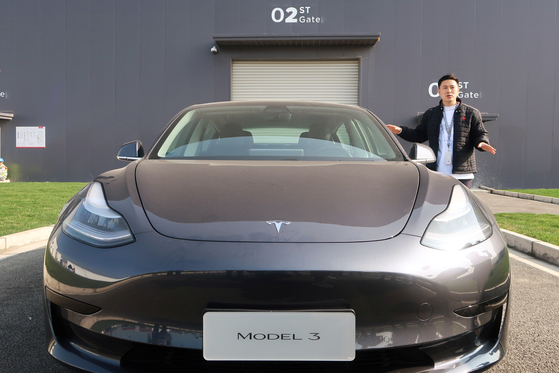 An employee explains the Tesla Model 3 vehicle at the company's Shanghai Gigafactory in Shanghai, China. [REUTERS]