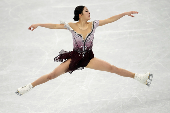 You Young performs a split jump in the women's free skate program during the figure skating competition at the 2022 Winter Olympics on Thursday. [AP/YONHAP]