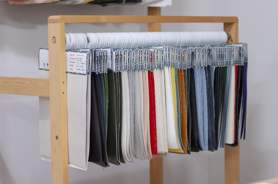 A rack of the various colors of Haunji, or artificial leather made from hanji, a type of Korean traditional paper that is made from the branches of mulberry trees [HANWON MULSAN CORPORATION]