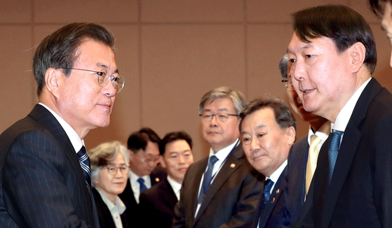 President Moon Jae-in, left, and President-elect Yoon Suk-yeol, prosecutor general at the time, face each other at the Blue House in central Seoul on Nov. 8, 2019. [JOINT PRESS CORPS]