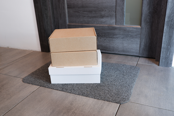 Parcels are left in front of a door. In Korea, packages are left generally outside to avoid unnecessary contact during the Covid-19 pandemic. [SHUTTERSTOCK]