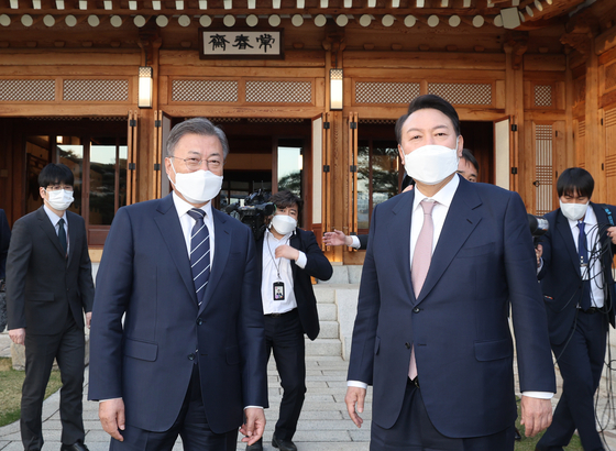 President Moon Jae-in, left, and President-elect Yoon Suk-yeol pose for a photo ahead of their first dinner meeting at the Blue House in central Seoul Monday, 19 days after the election. [JOINT PRESS CORPS]