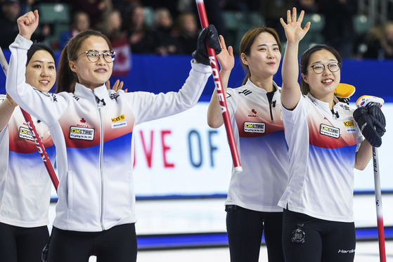 From left to right: Kim Kyeong-ae, skip Kim Eun-jung, second Kim Cho-hi and lead Kim Seon-yeong celebrate after defeating Canada during the World Women's Curling Championship in Prince George, British Columbia on Saturday. [AP/YONHAP]