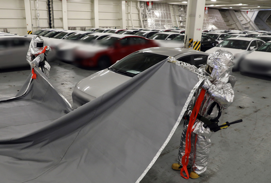 Hyundai Glovis' employees conduct a fire drill on a car carrier. [HYUNDAI GLOVIS]