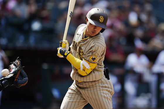 San Diego Padres' Kim Ha-seong gets hit by a pitch during a game against the Arizona Diamondbacks on Sunday in Phoenix, Arizona. [AP/YONHAP]