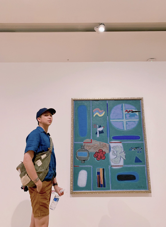 RM poses next to a painting by modern art master Kim Whanki (1913-1974) at the Buk Seoul Museum of Art in 2019. [BTS TWITTER]
