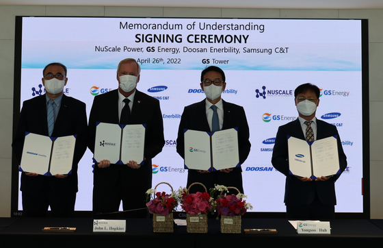 Executives from Samsung C&T, GS Energy, NuScale Power and Doosan Enerbility pose for a photo after signing a memorandum of understanding on Tuesday at GS Tower, Gangnam District, southern Seoul. [GS ENERGY]