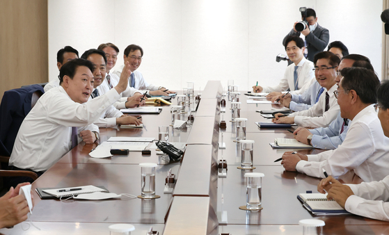 President Yoon Suk-yeol speaks at his first meeting with senior presidential secretaries at the presidential office in Yongsan District, central Seoul Wednesday, with jackets off for a more casual look. [YONHAP]