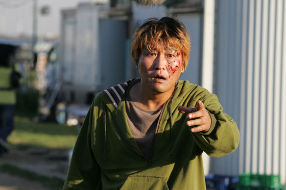 In “The Host,” Song plays Gang-du, a slow-witted vendor who takes care of his father’s shop near the Han River. His life changes when a monster created from environmental pollution kidnaps his daughter Hyun-seo (portrayed by Go Ah-sung). [SHOWBOX]