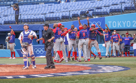 Members of the Dominican team celebrate after a score during a baseball game with Korea during the 2020 Tokyo Olympics in Yokohama Stadium on Aug. 7, 2021. [JOINT PRESS CORPS]