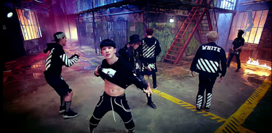 Wonho shows off his abs in Monsta X's debut track "Trespass" (2015). [SCREEN CAPTURE]