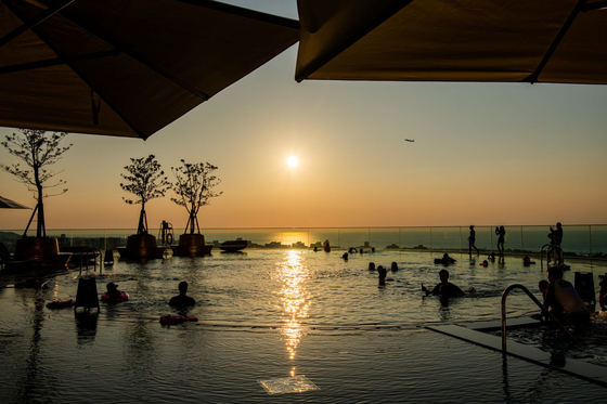 Hotel guests at the Grand Hyatt Jeju enjoy time at the pool. [LOTTE TOUR]