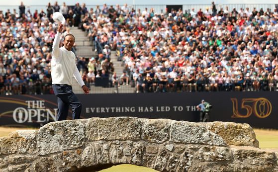 Tiger Woods waves from the Swilcan Bridge at the 18th hole during the second round at the 150th Open Golf Championships in St. Andrews, Scotland on Friday.  [EPA/YONHAP]